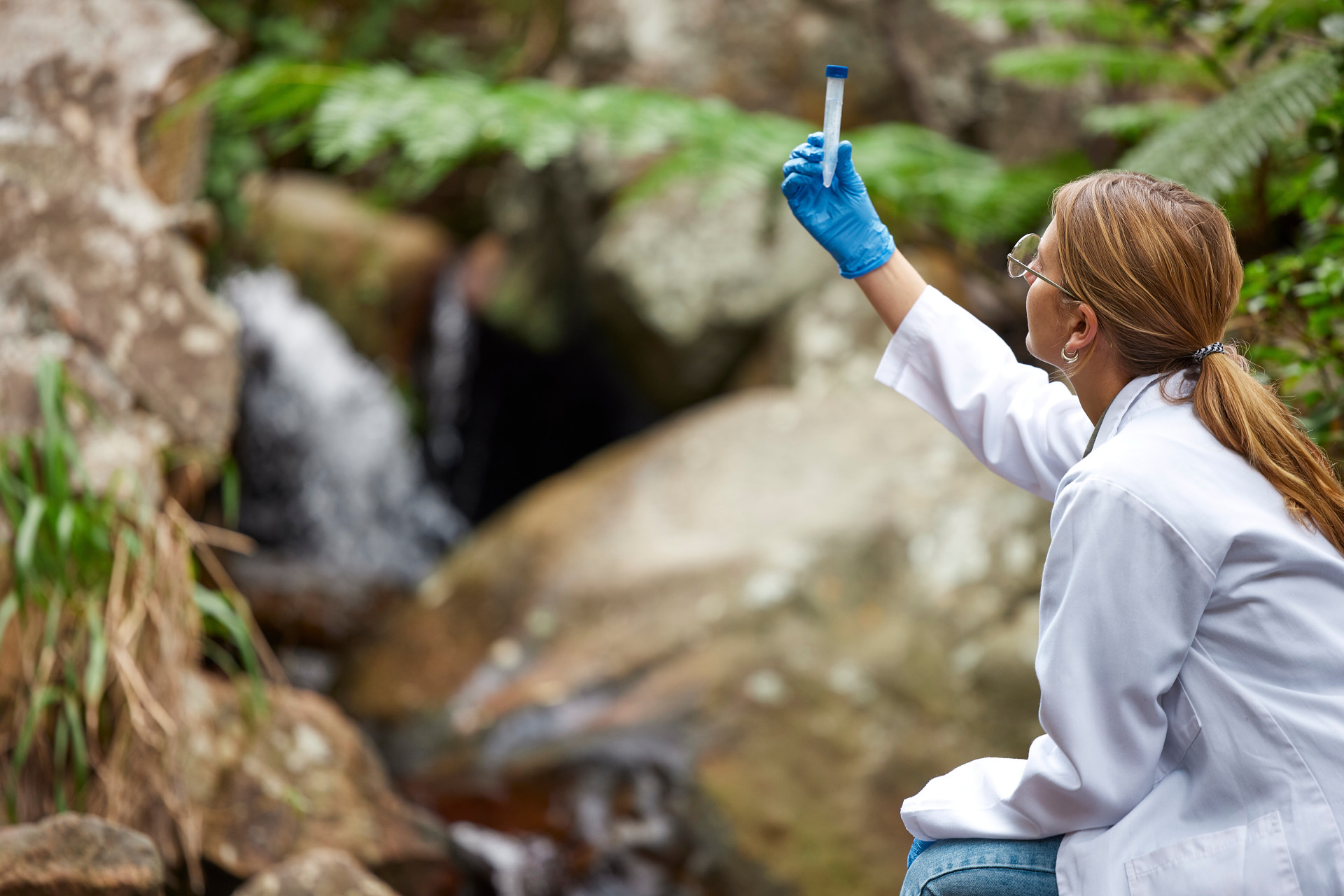 Science, nature and woman with water in test tube for inspection, environment and ecosystem study. .